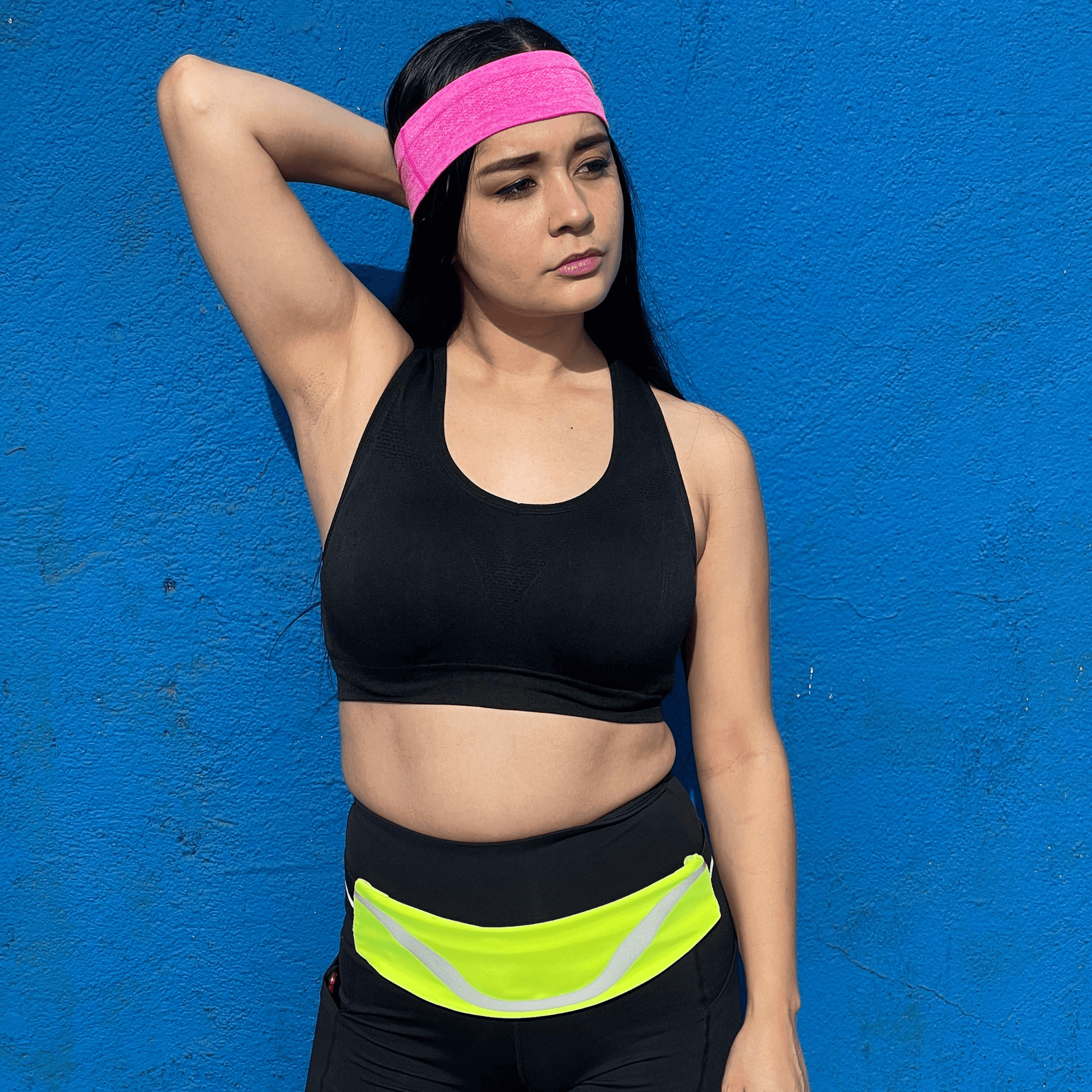 Water-resistant sport waist pack running belt with neon green reflective stripe, worn at waist.