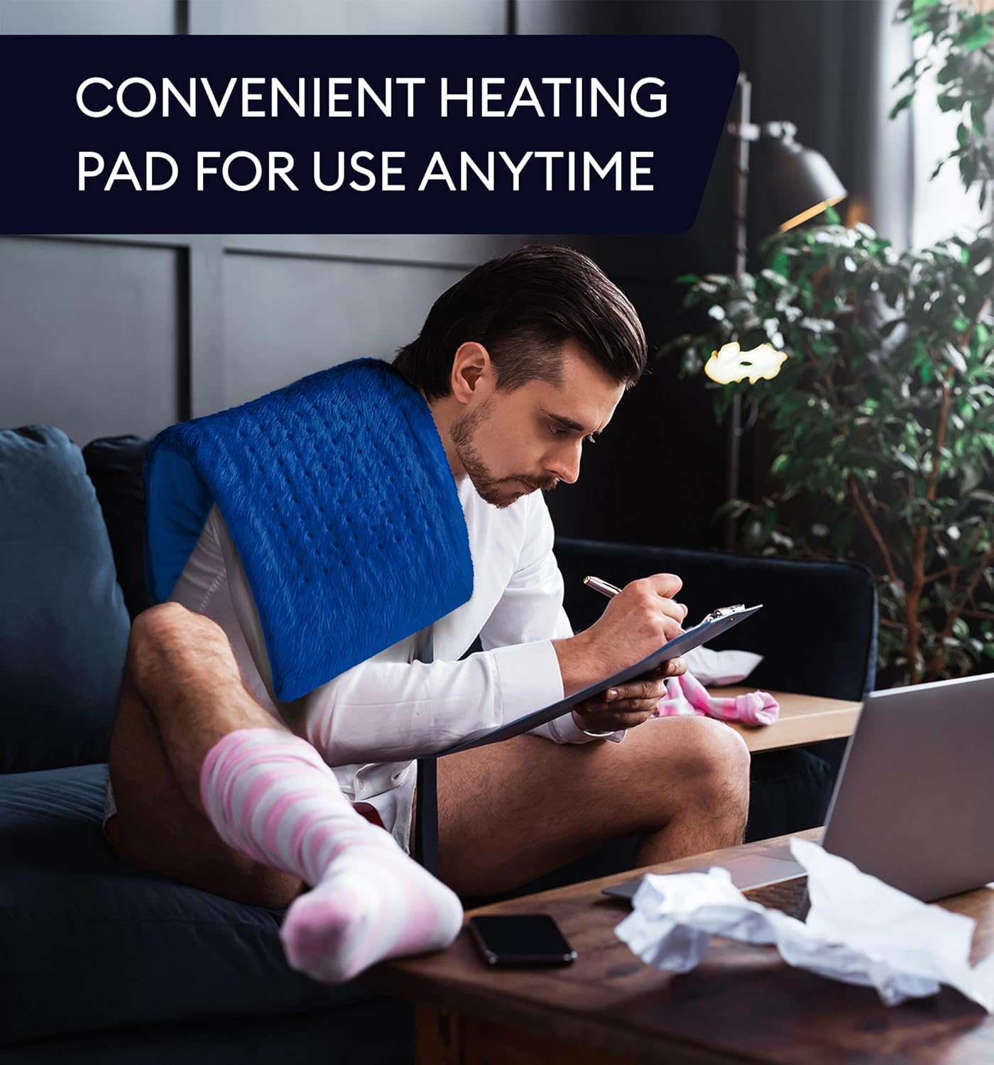 Space blue heating pad on couch with handheld controller