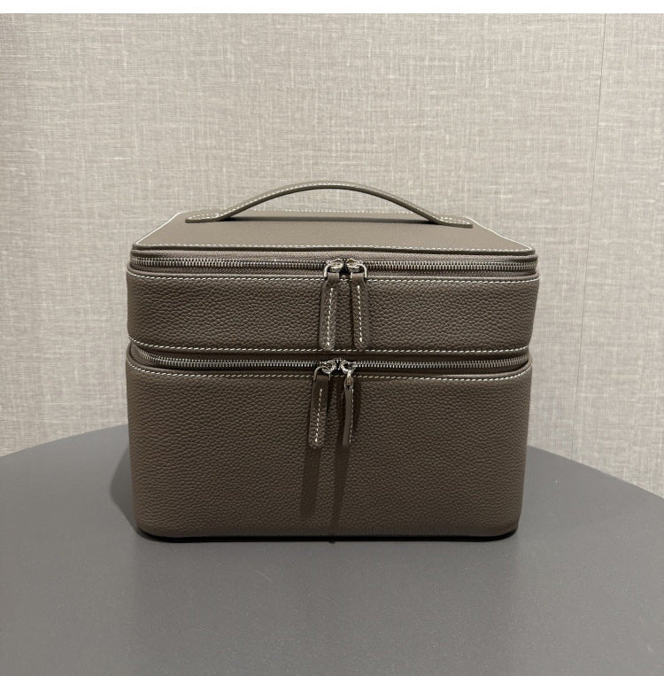 Gray leather-look jewelry storage tote with double zippers and top handle