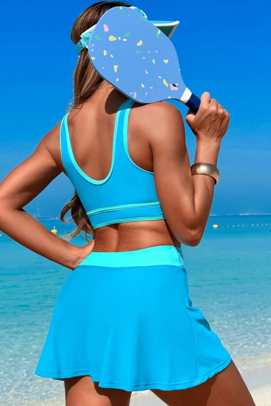 Blue two-piece swimsuit with high-waisted skirt and racerback cropped tank top