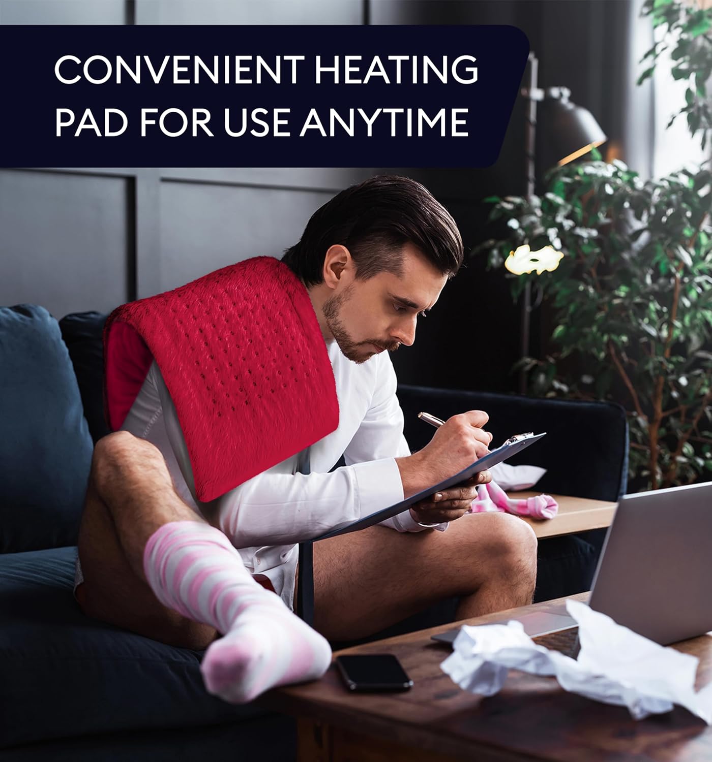 Viva magenta heating pad draped on a person’s back, plush dotted surface