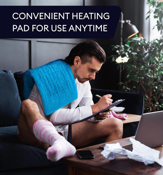 Aqua blue heating pad wrapped around an adult’s shoulders with power controller