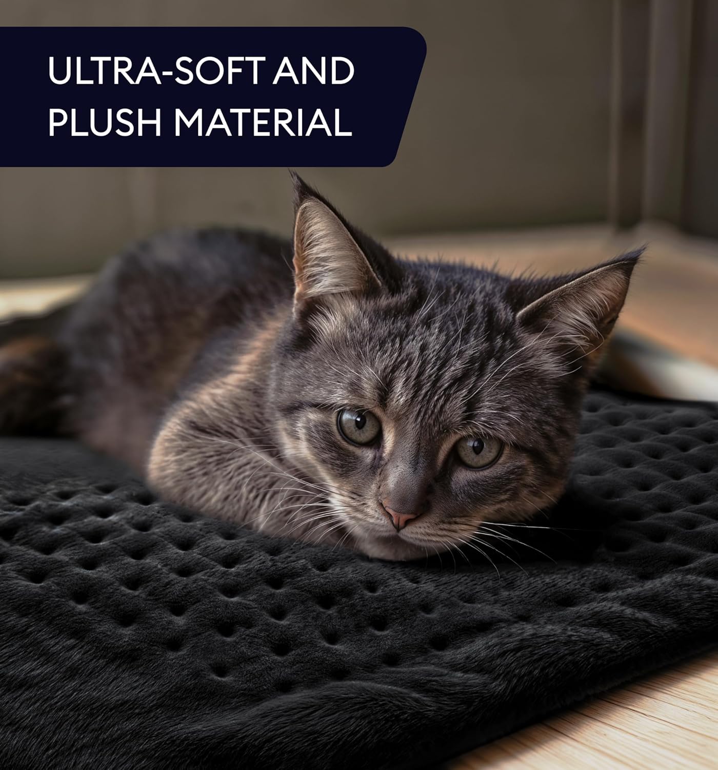 Black ultra-soft heating pad with embossed texture, shown with a lying cat