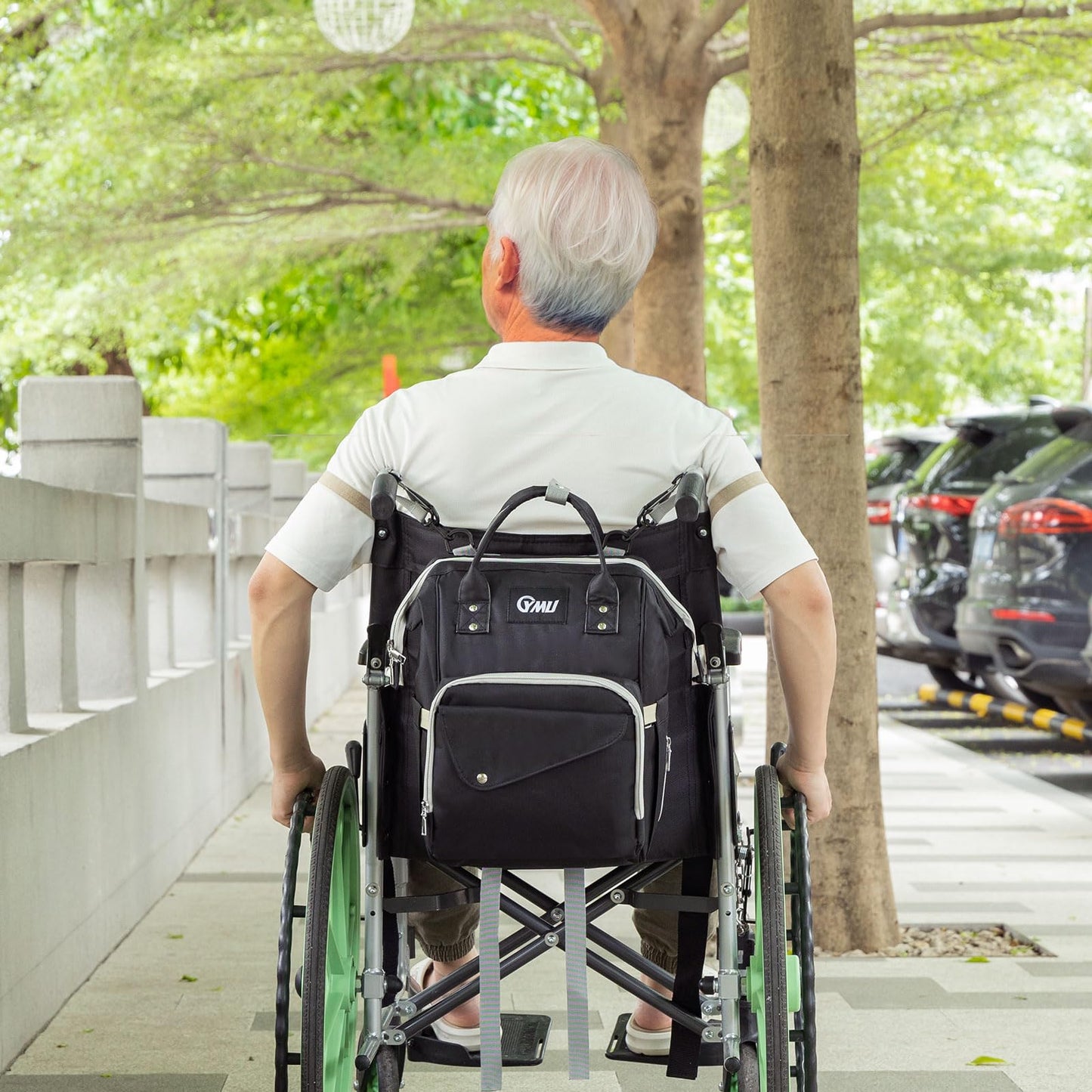 Black wheelchair backpack bag worn on a wheelchair backrest with front main and side pockets
