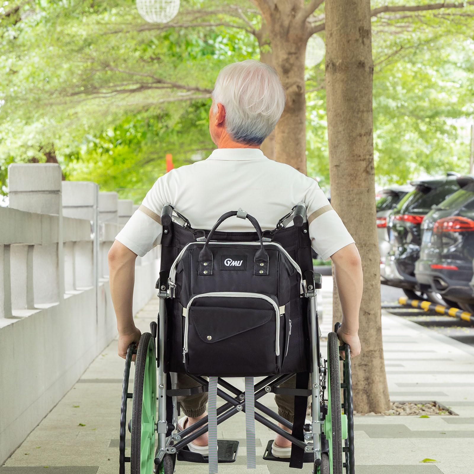 Black wheelchair backpack bag worn on a wheelchair backrest with front main and side pockets