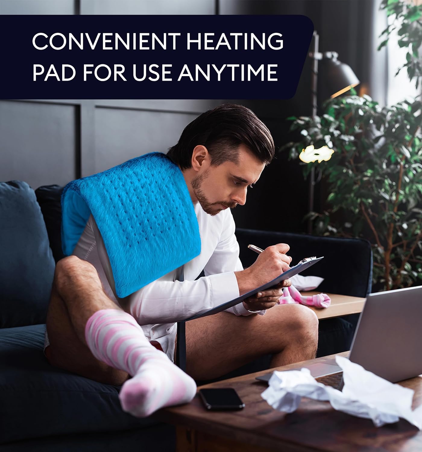 Aqua blue plush heating pad XL on couch for heating while using a tablet