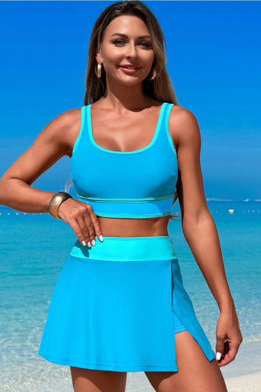 Blue two-piece swimsuit with high-waisted skirt and matching cropped tank top