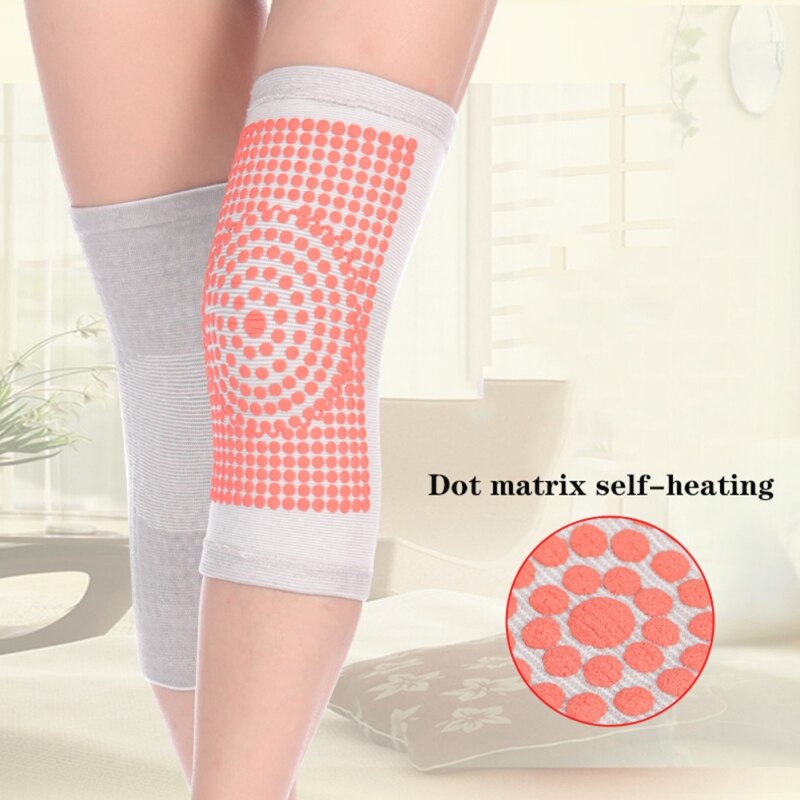 Grey self-heating knit knee pad with red dot heat panel at the knee