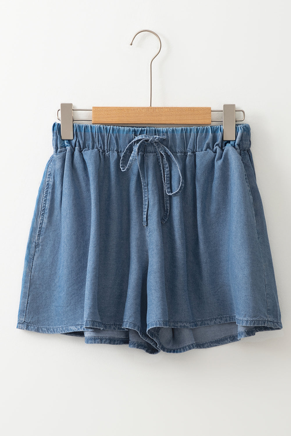 Dusk blue denim shorts on hanger, elastic waistband with drawstring