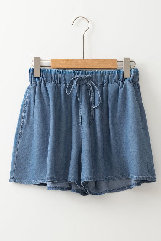 Dusk blue denim shorts on hanger, elastic waistband with drawstring