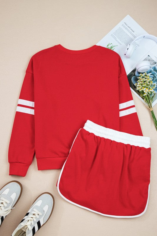 Red pullover sweatshirt and mini skirt set with white-striped cuffs and elastic lace-up waist