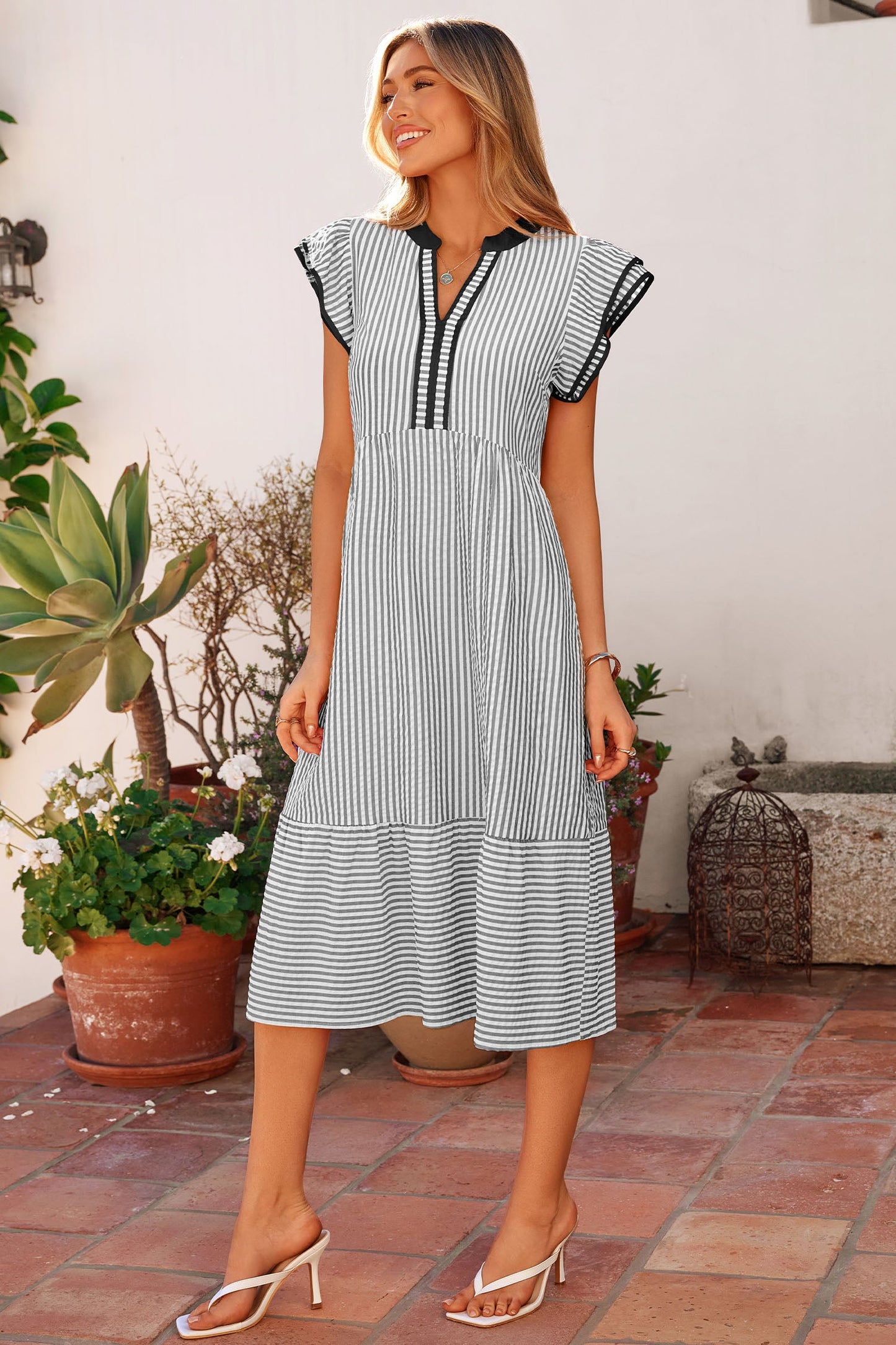 Long striped midi dress with V-neck tassel placket and tiered skirt hem