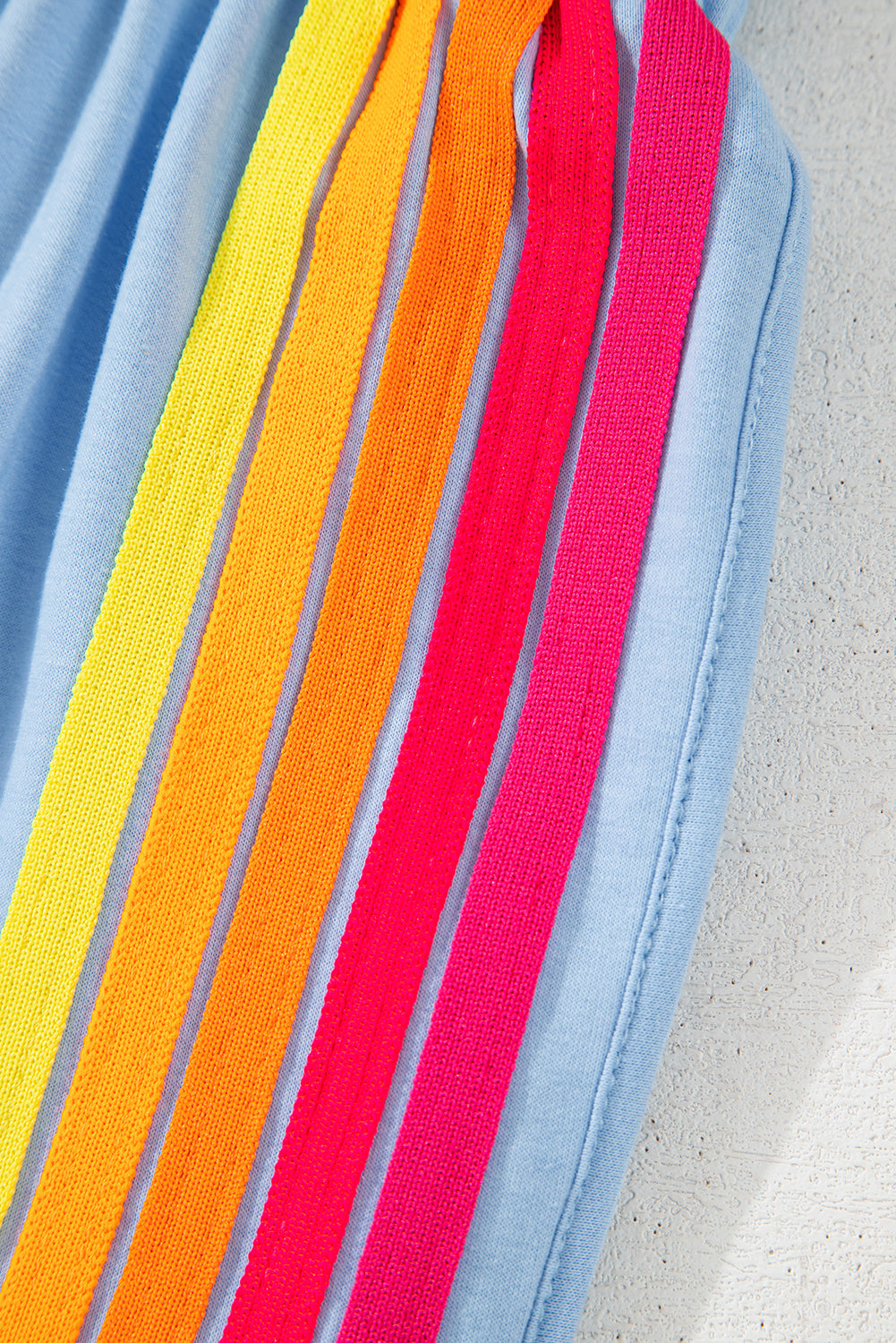 Rainbow vertical stripe trim on light blue high-waist active shorts