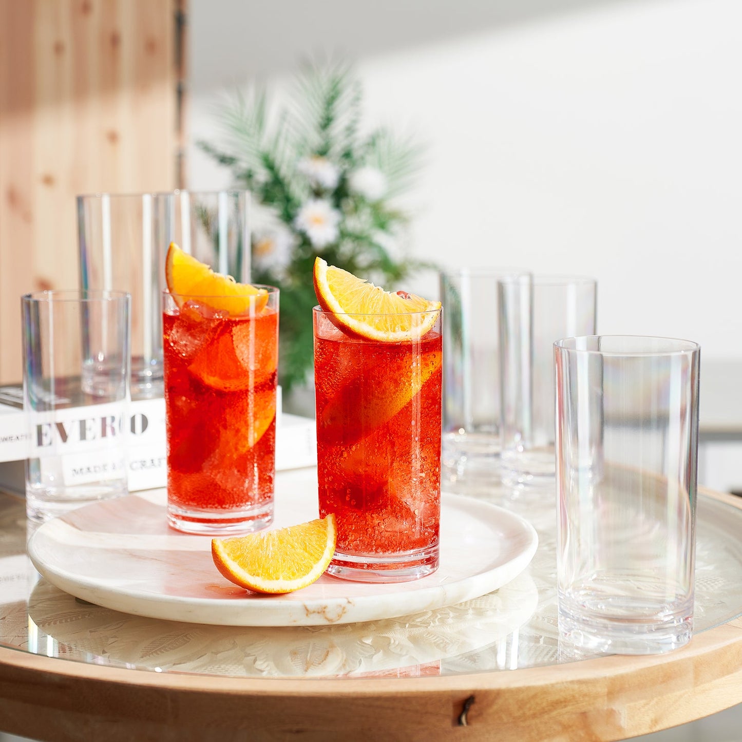 Acrylic highball glasses: two filled with red drink and orange slices, four clear