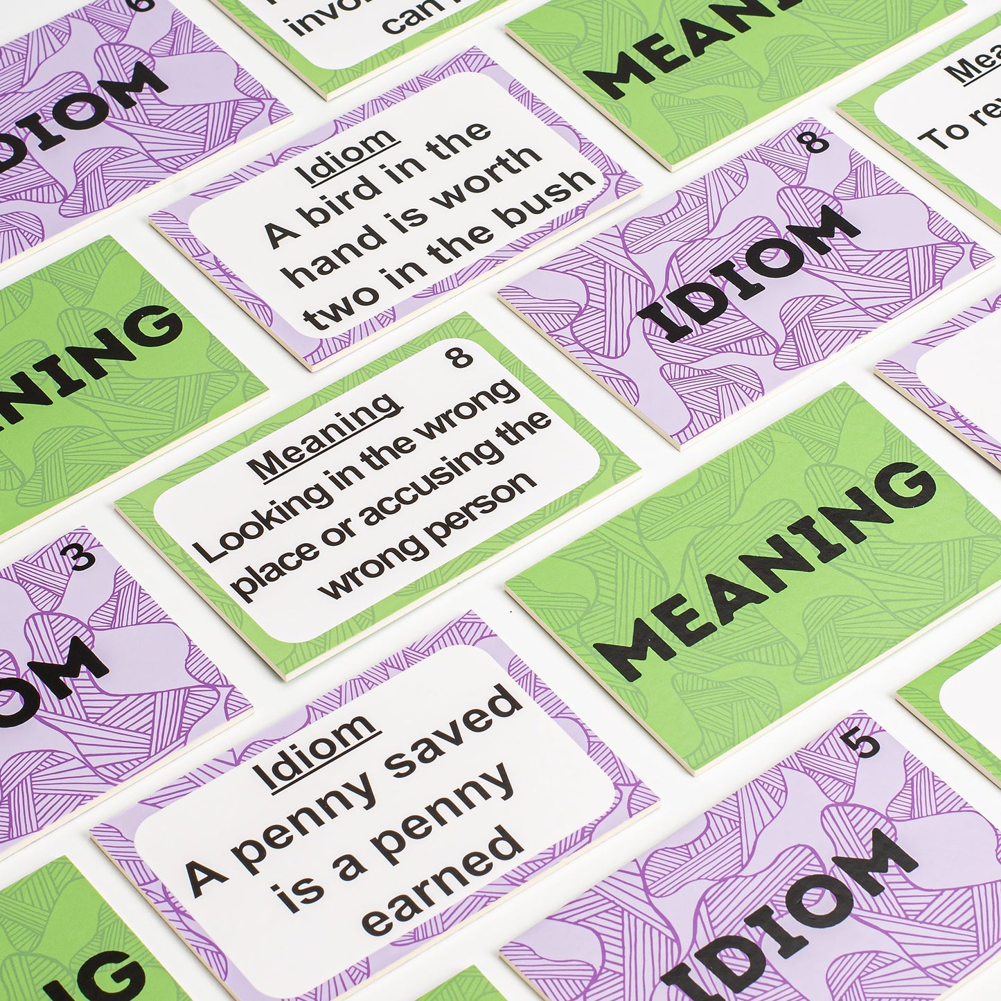 Idiom and meaning matching cards with colorful patterned borders and printed prompts