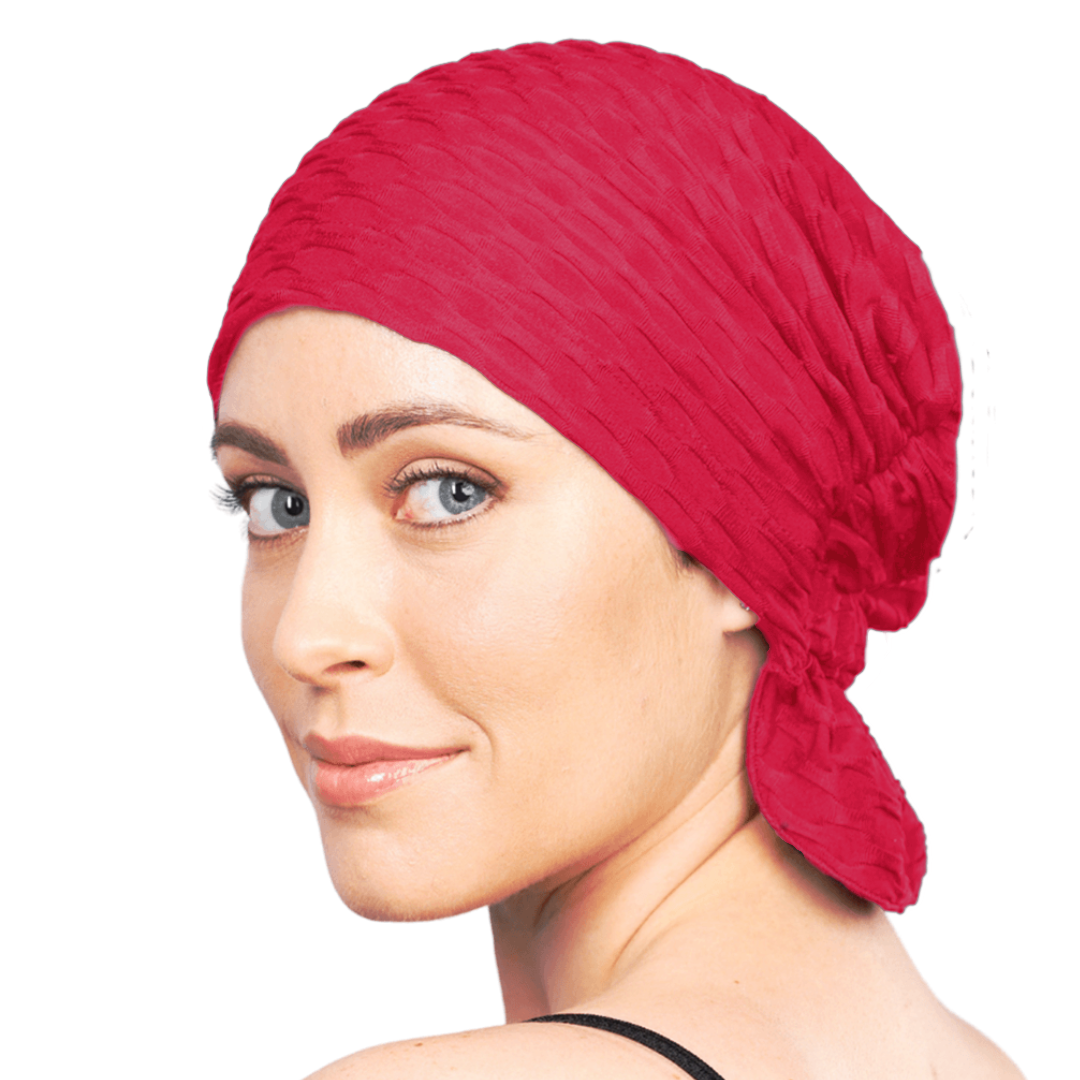 Red chemo beanie with textured knit and flared side tail