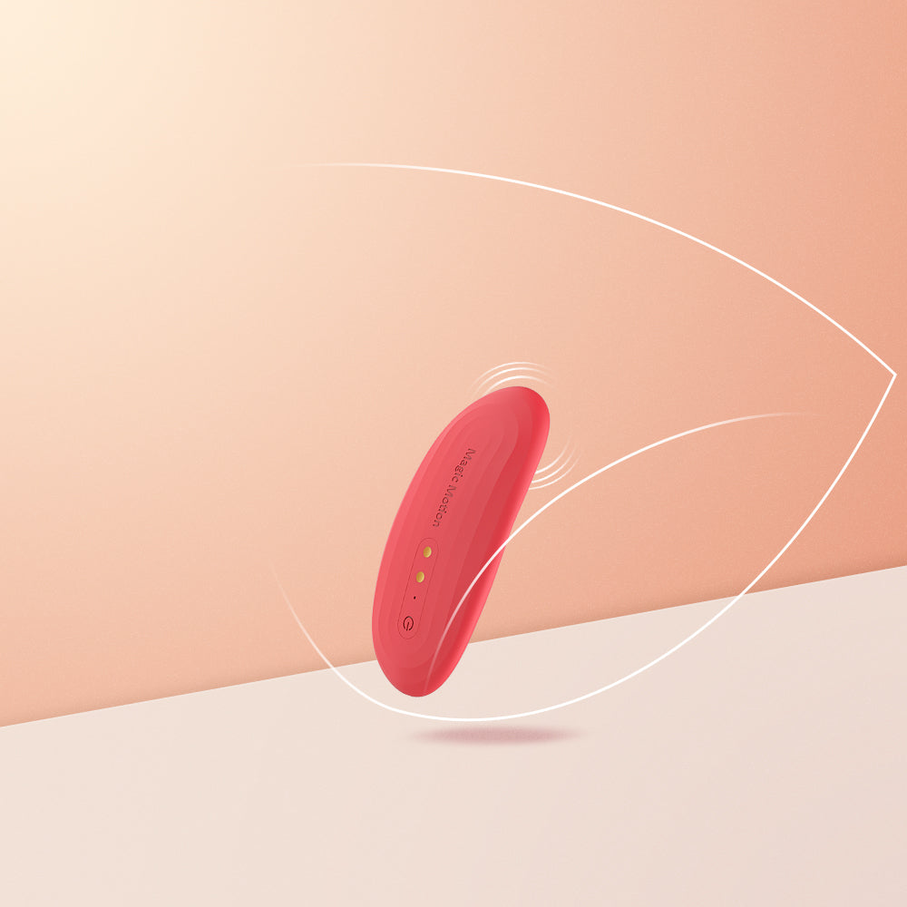 Red oval smart vibrator on a surface with motion lines indicating vibration