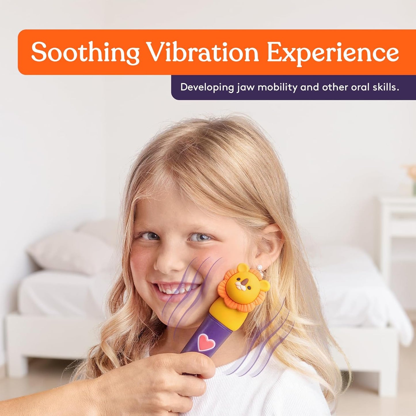 Child holding lion-headed vibrating oral motor tool near the mouth