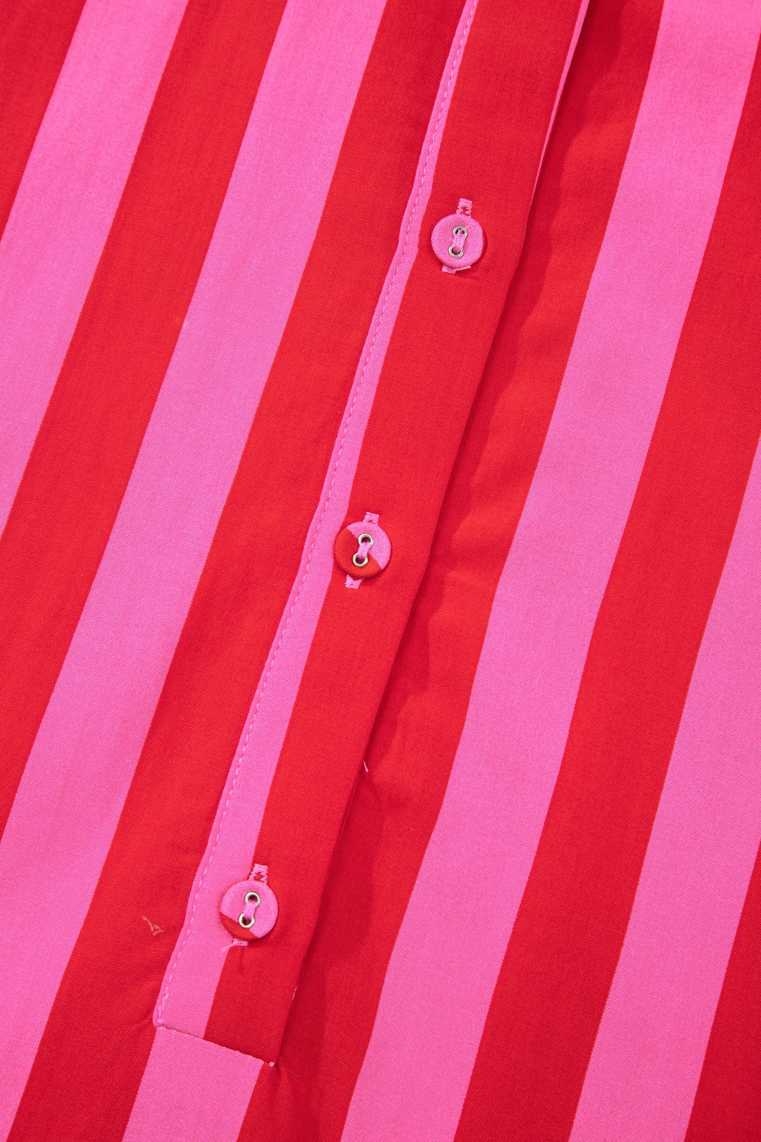 Pink and red striped dress placket with small pink button accents