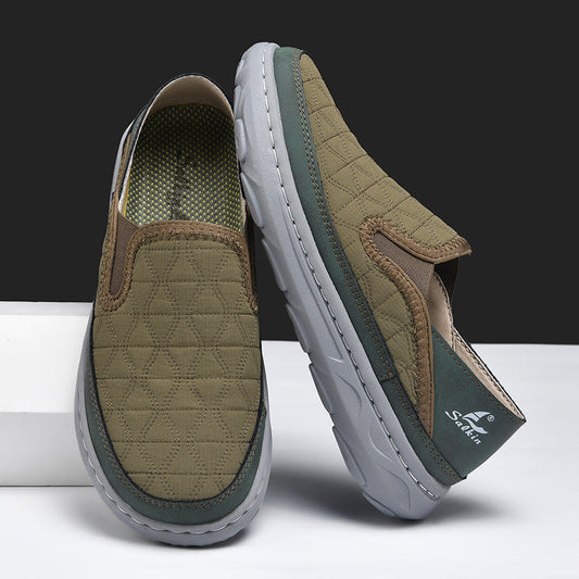 Men's casual travel shoes in tan with teal trim, slip-on design and cushioned sole
