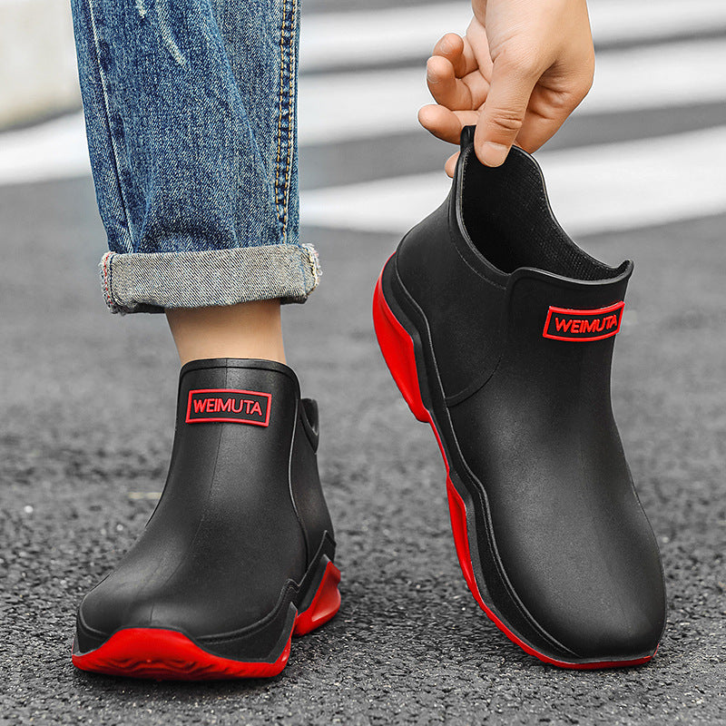 Men's short rain boots in black with red trim, pull-on style and logo patch
