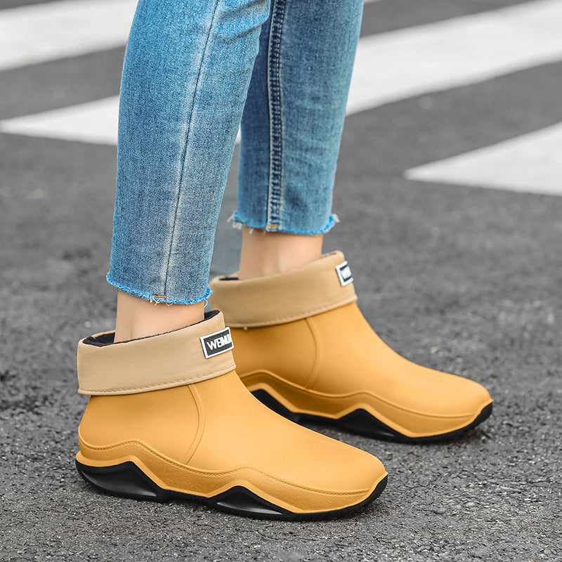Men's short rain boots, tan/yellow with black sole, slip-on ankle style with logo patch