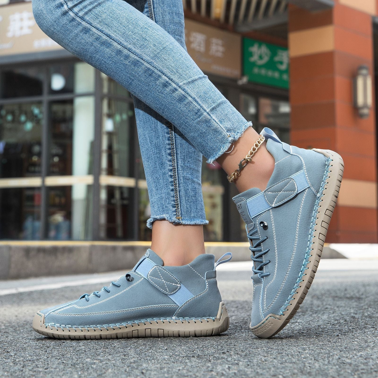 Casual leather boots in light blue with lace-up front, padded collar, and ridged sole.