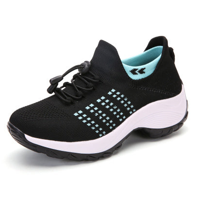 Women’s athletic knit sneaker in black with teal dots, lace-up, white sole