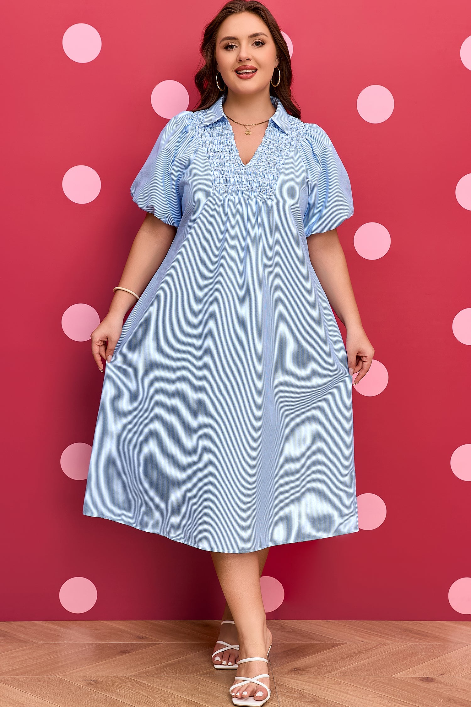 Plus-size light blue striped midi dress with smocked neckline and V-shaped yoke detailing.