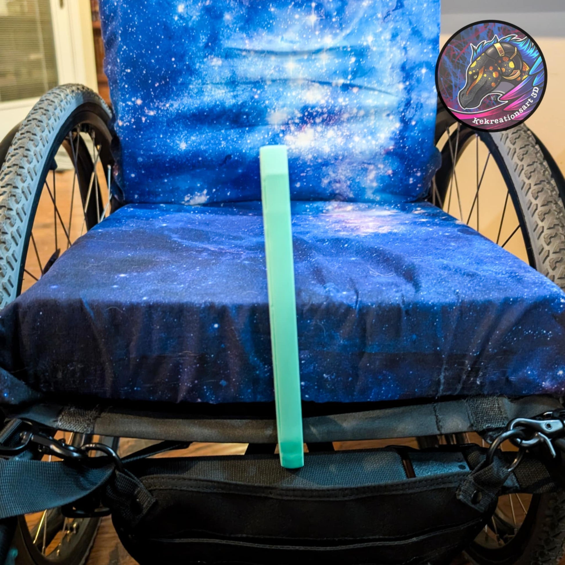 Light blue/teal wheelchair bag hook upright on seat area for hands-free carry