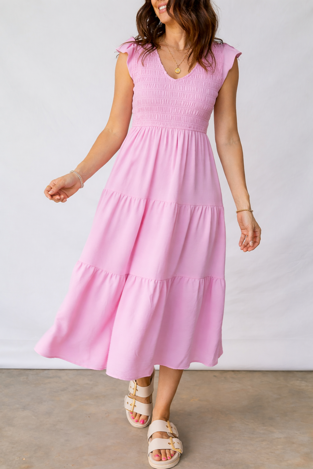 Pink tiered midi dress with V-neck smocked bodice and layered skirt