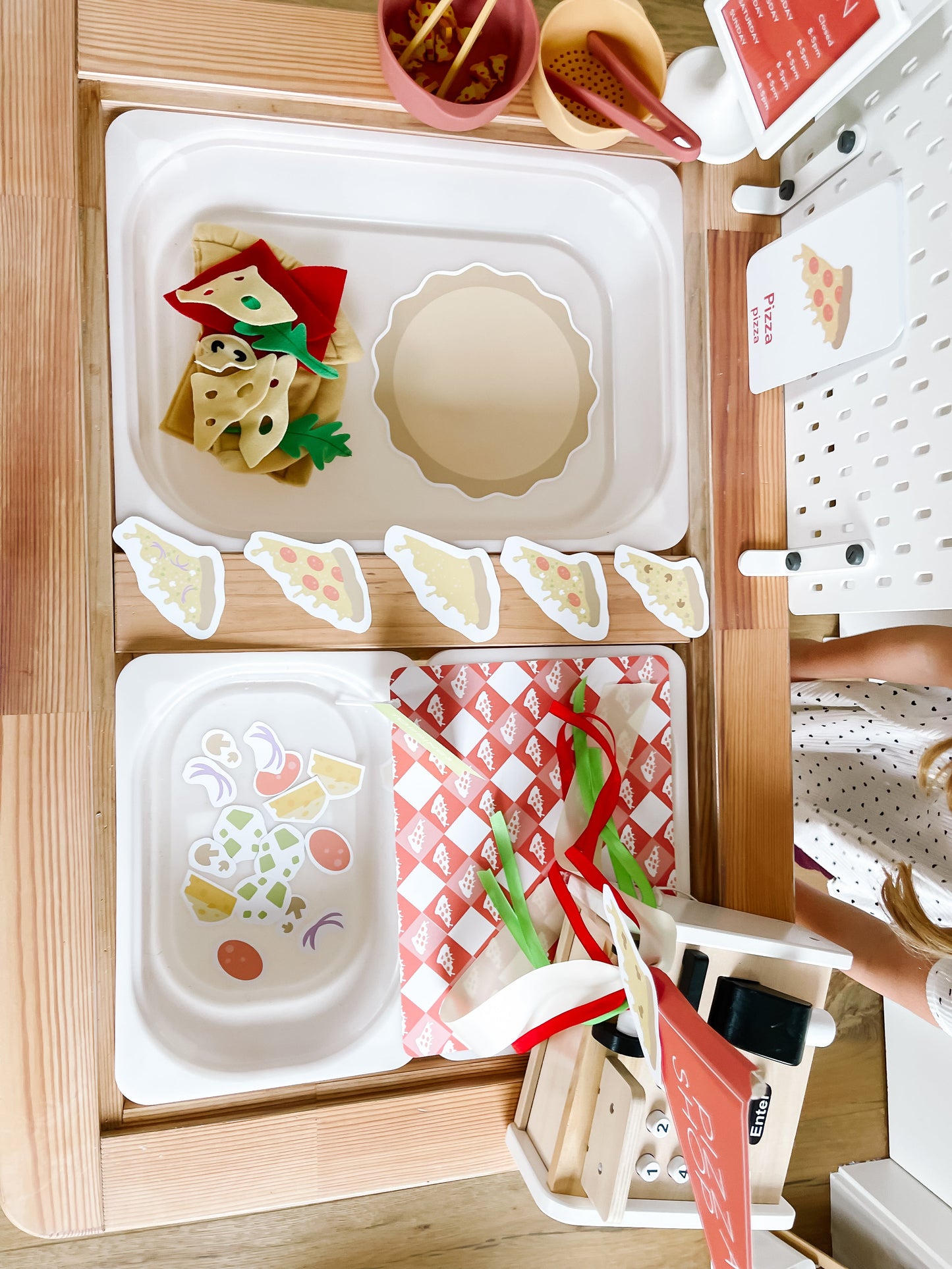 Pizza shop play kit top view with food trays, pizza cutouts, and toppings cards