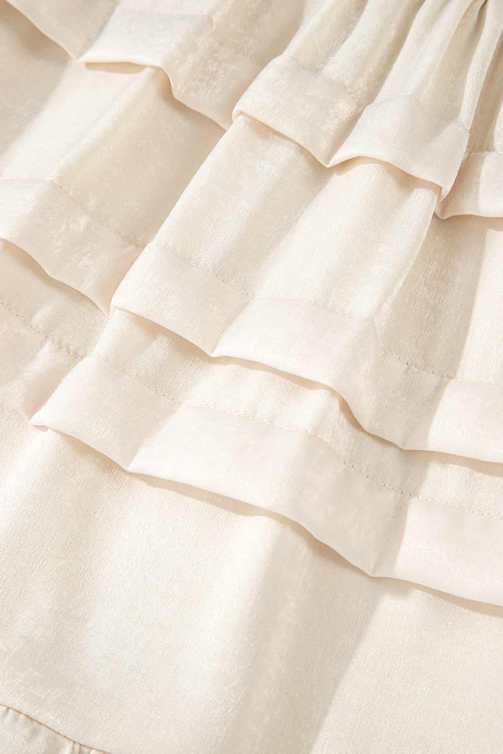 Beige tiered mini skirt with textured layered ruffle bands