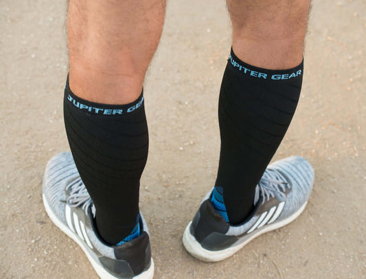 Black compression socks with blue arch band and light blue heel/toe accents