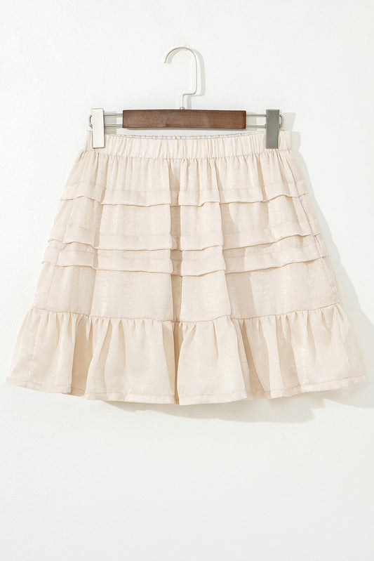 Beige tiered mini skirt with elastic waistband and layered ruffle panels
