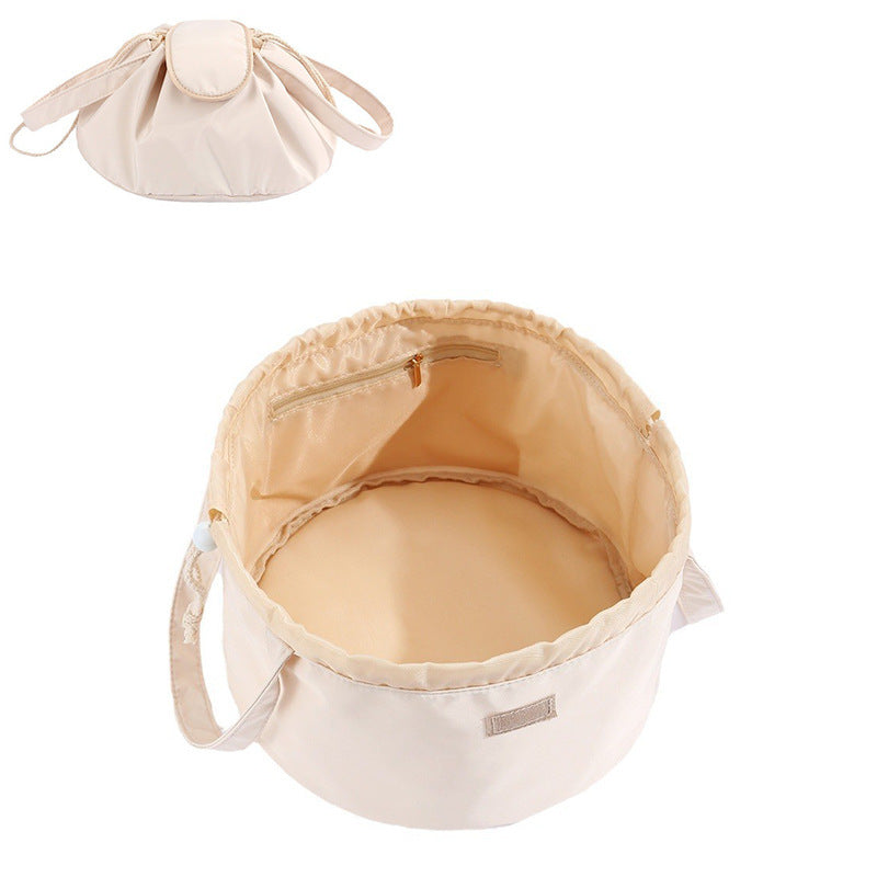 Cream barrel drawstring makeup bag with top zipper, inner pocket, and side handle