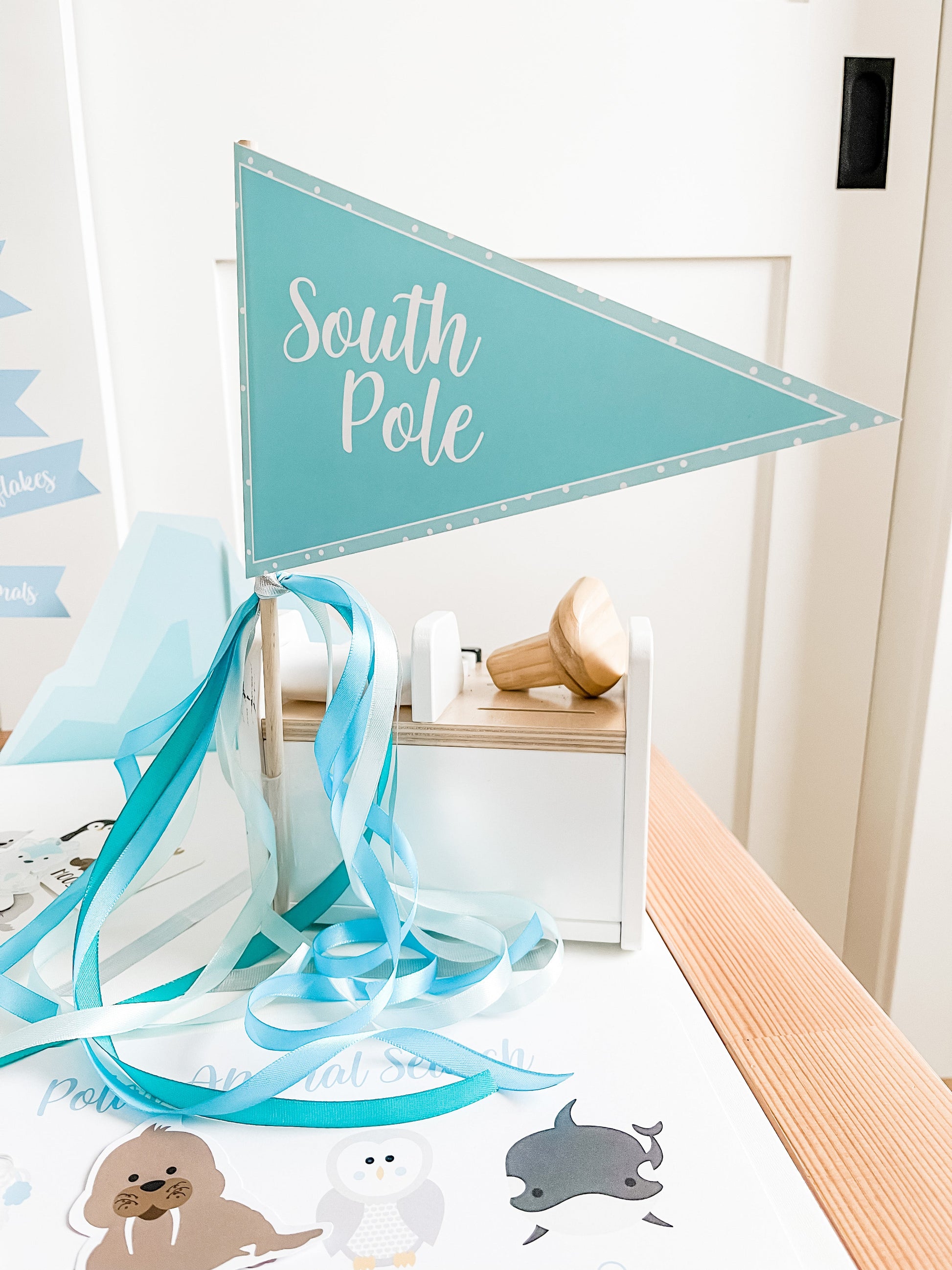 Polar themed play mat with South Pole banner and blue ribbon streamers