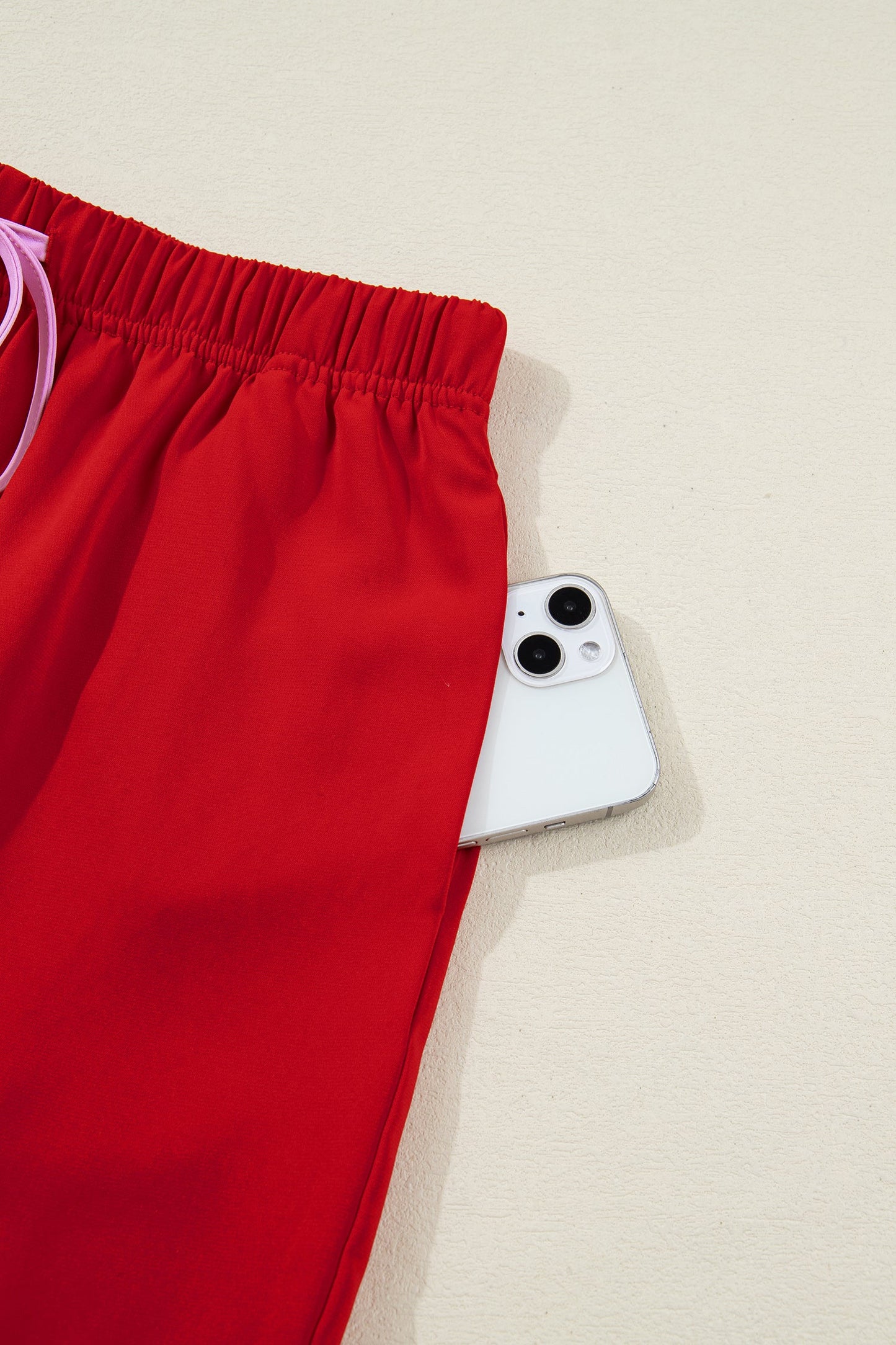 Red pajama shorts with elastic waistband and white drawstring detail