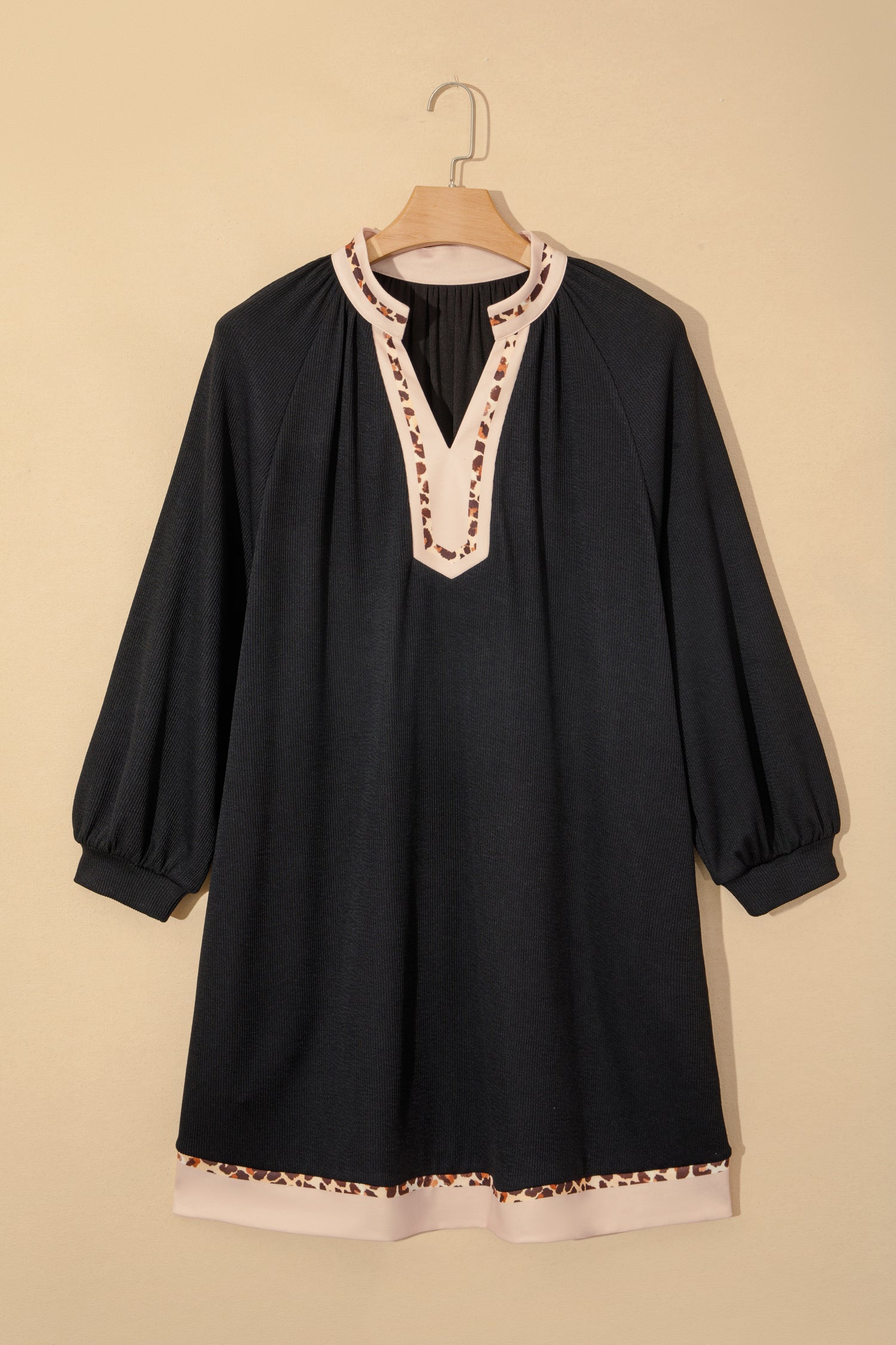 Black ribbed A-line dress on hanger, V-neck with leopard block trim and contrast hem