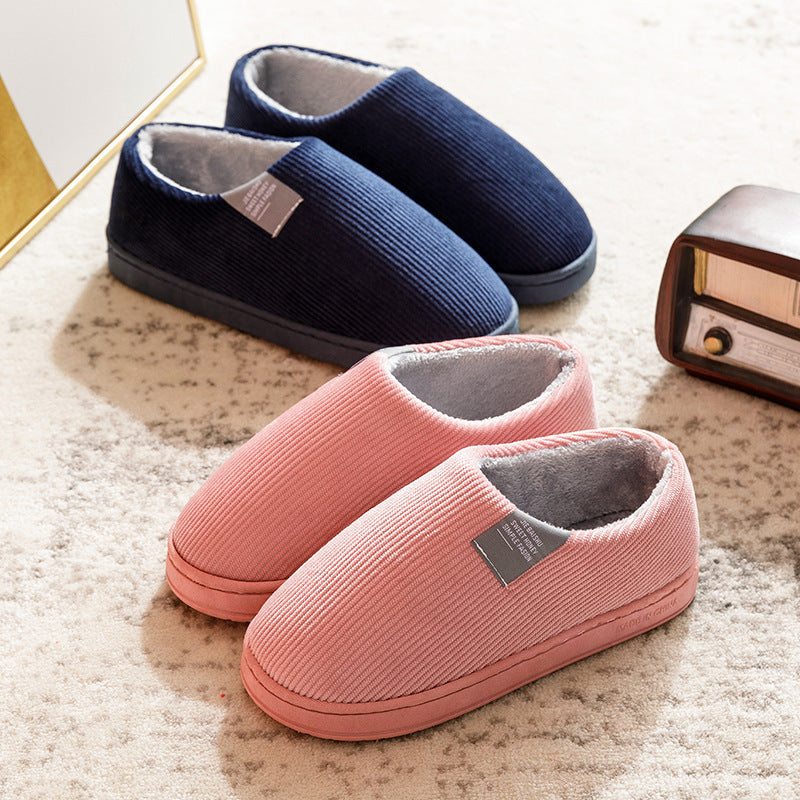Pink and navy women’s slip-on slippers with fuzzy gray lining and cushioned sole
