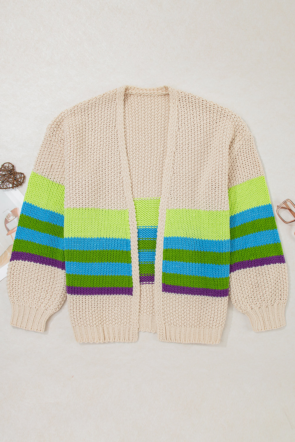 Plus-size crochet open-front cardigan flat lay, parchment with green blue and purple stripes