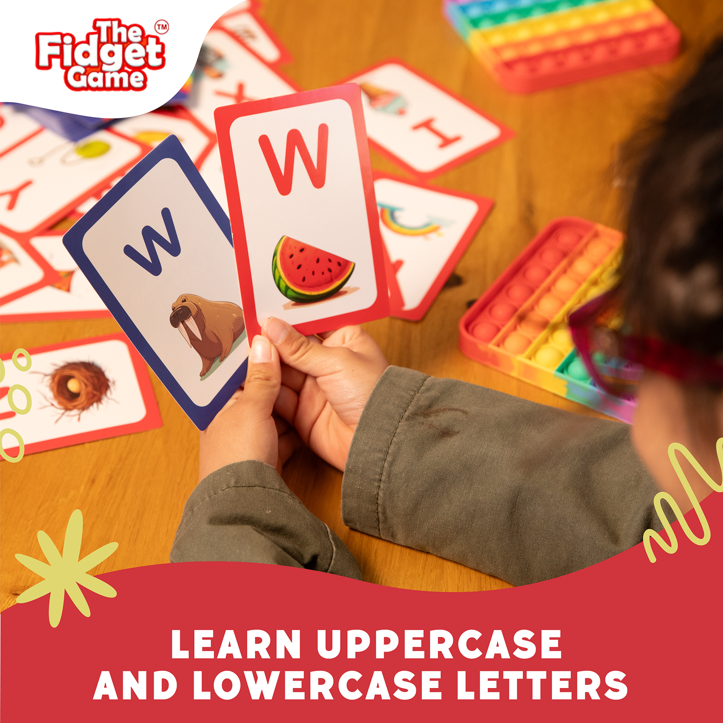 Hand holding uppercase and lowercase letter cards, showing W and w with other cards nearby