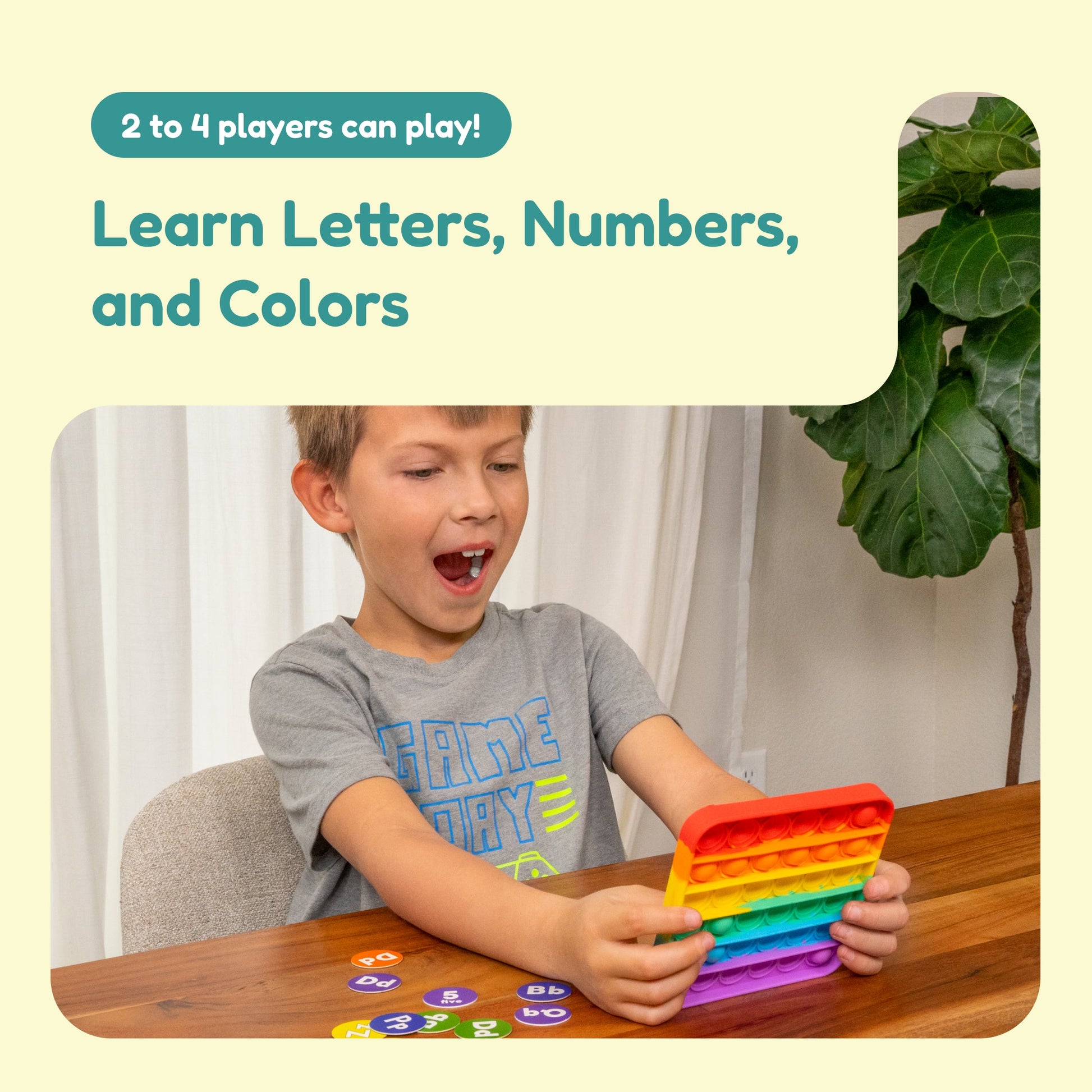 ABC Bingo rainbow pop-it mat held by a child, showing colorful letter-number bubbles
