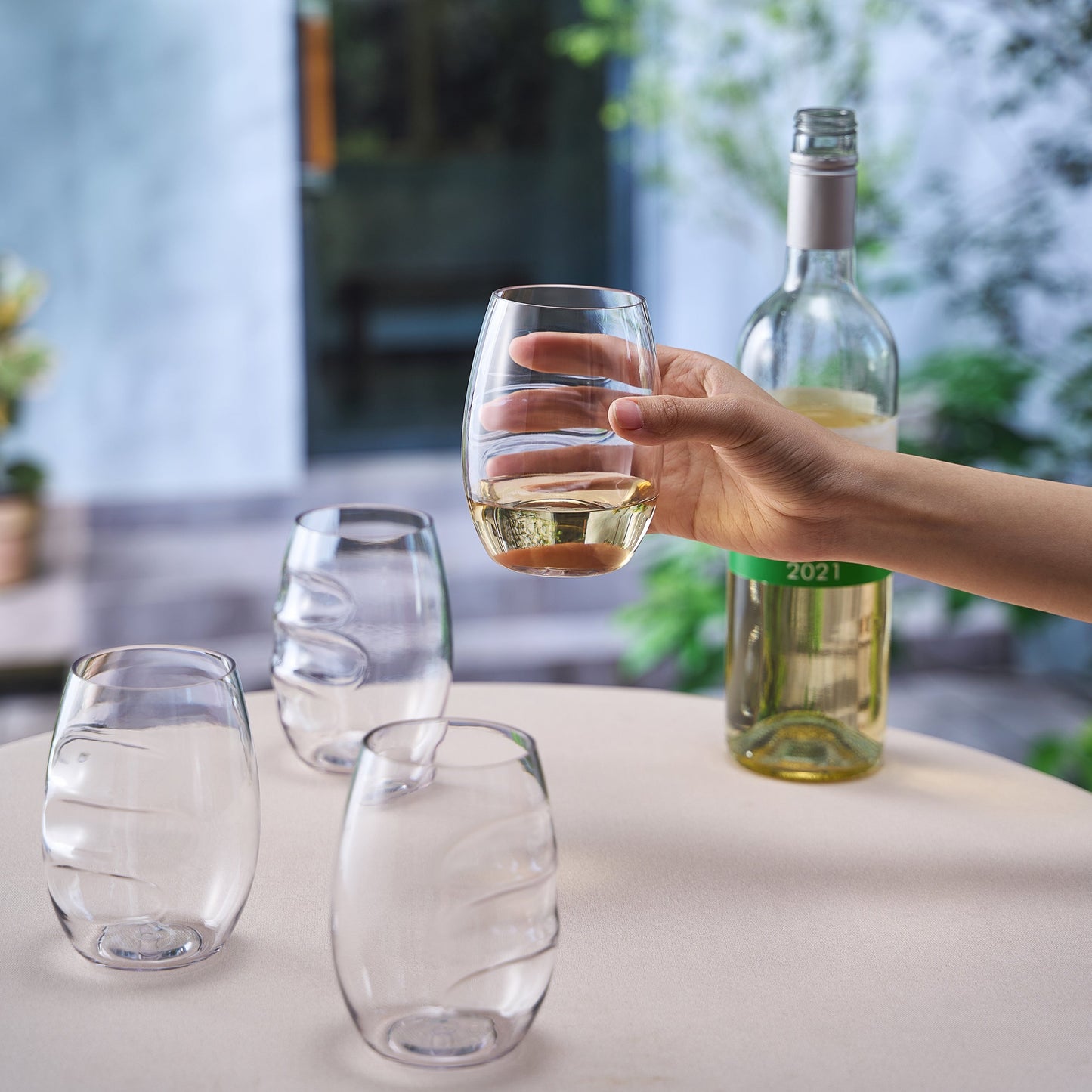 Stemless finger-indent wine glasses, set of 4, clear acrylic, one with white wine