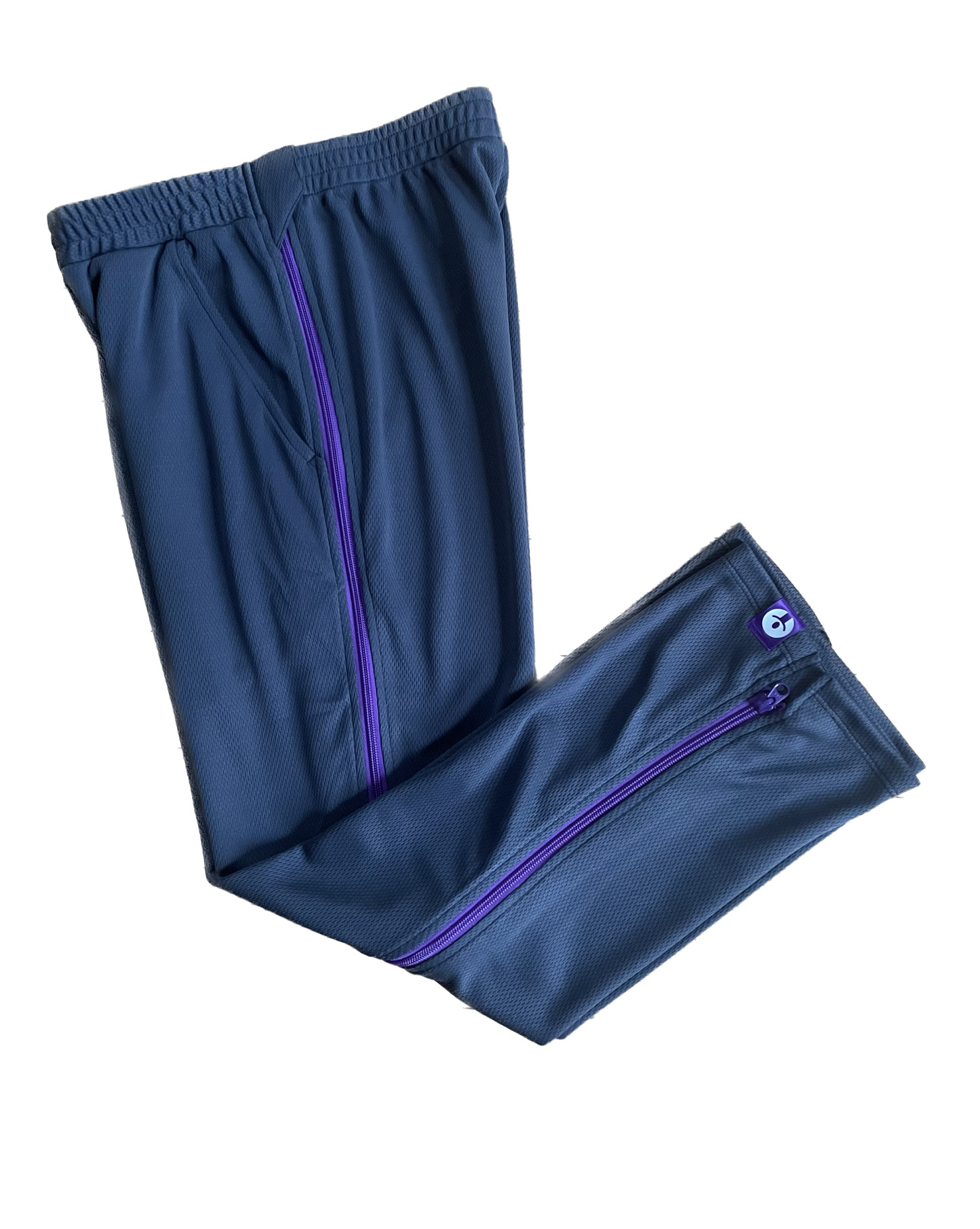 Blue athletic pants with purple zippers on a white background