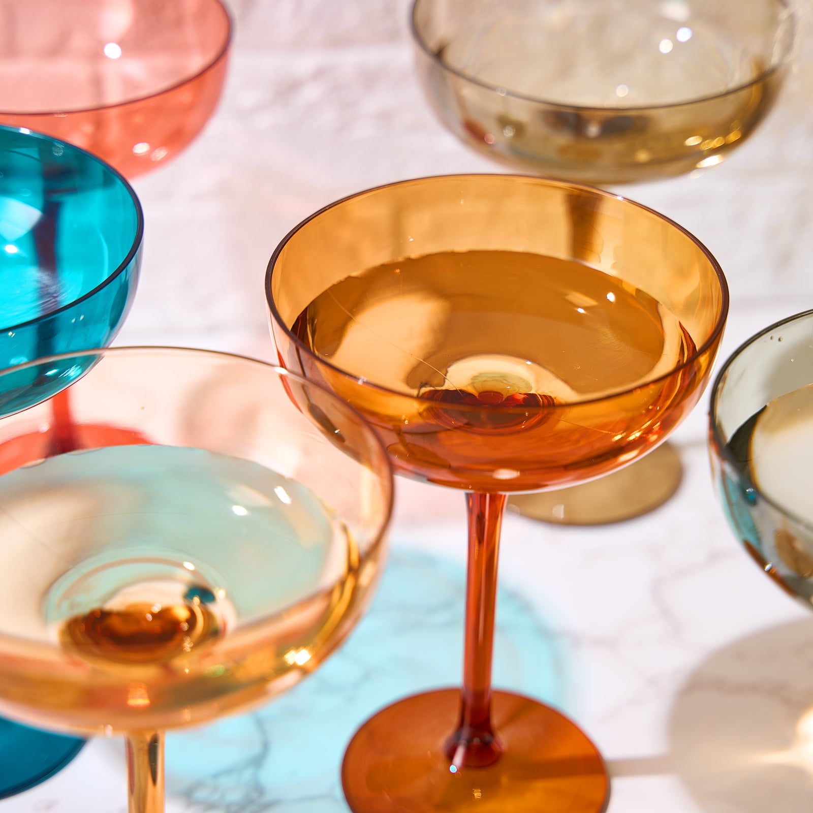 Amber acrylic champagne coupe cocktail glass with wide bowl and short stem