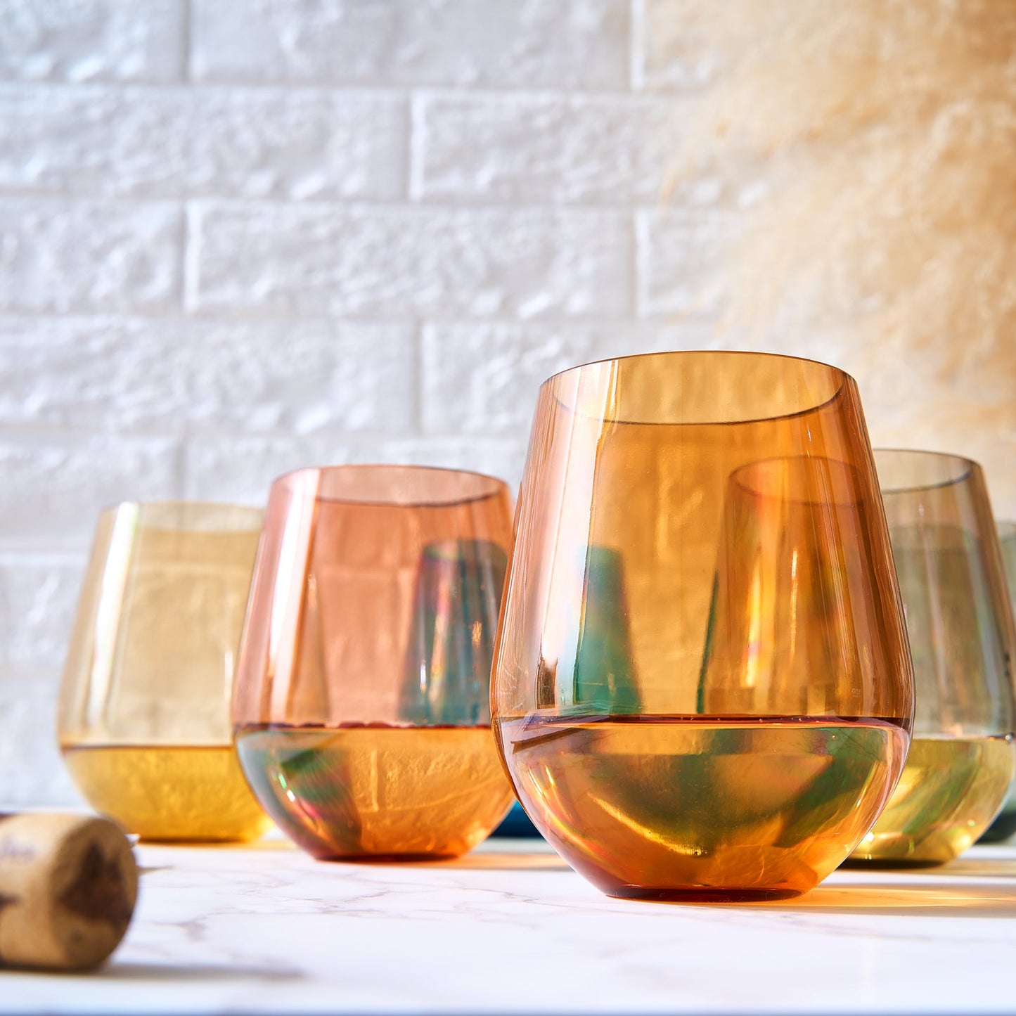 Stemless acrylic wine glass with warm amber color and round rim, part of set of 6