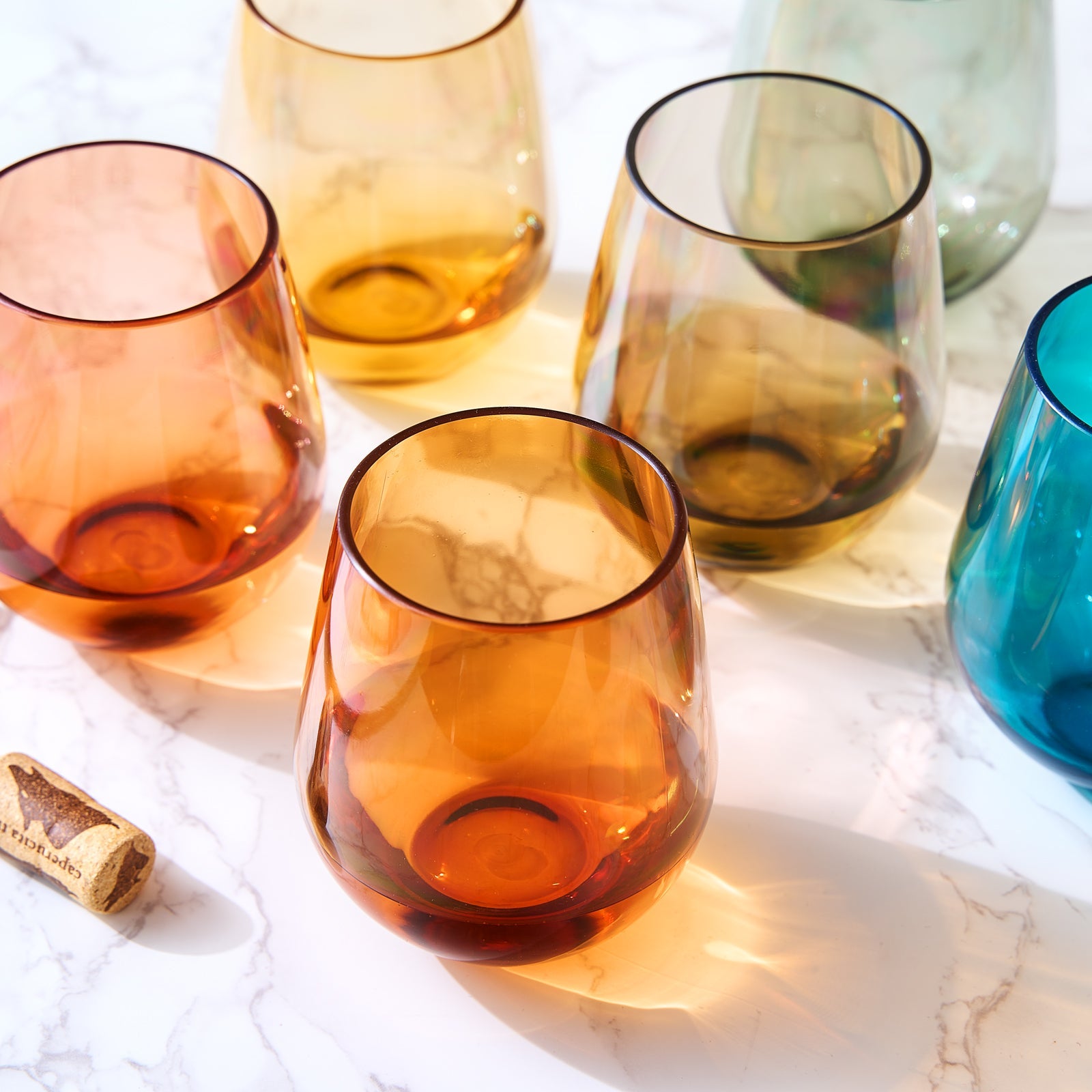 Set of 6 stemless acrylic wine glasses with orange, amber, green-tinted, and blue colors
