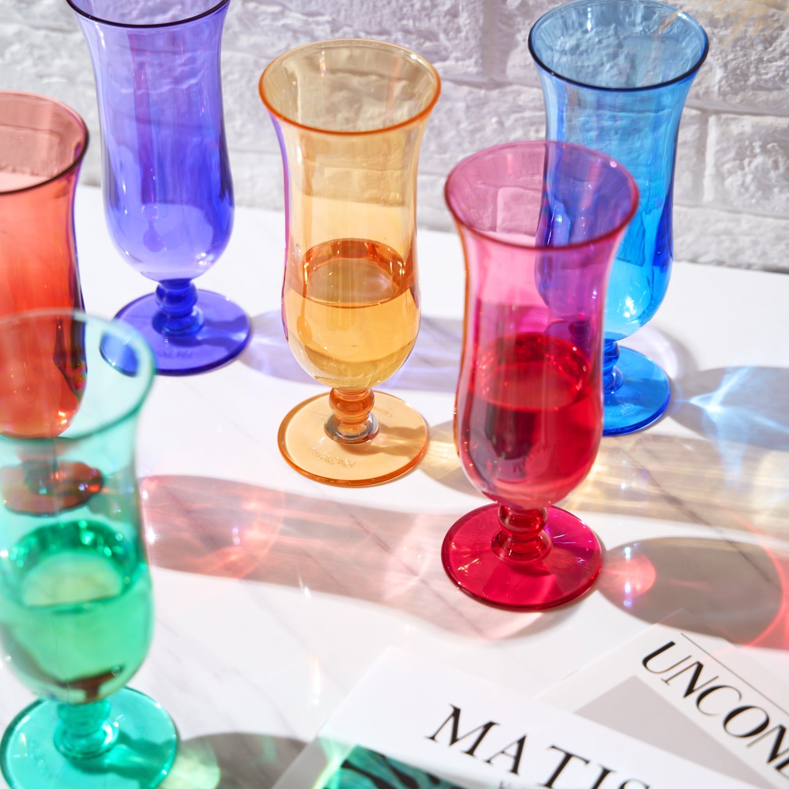 Acrylic hurricane cocktail glasses set of 6, close view of red, gold, teal, blue, and purple