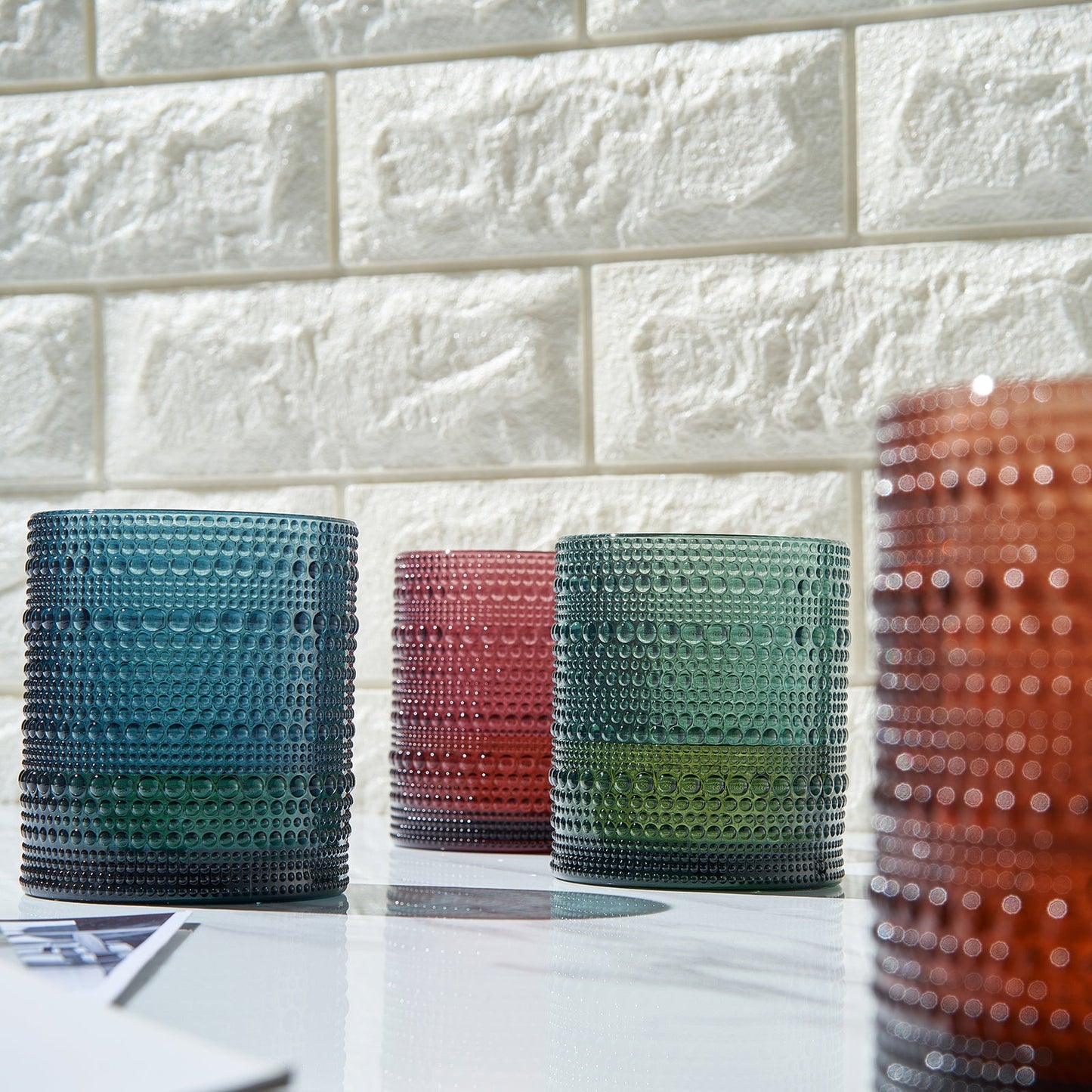 Four acrylic hobnail lowball cups in dark blue, teal, green, and copper